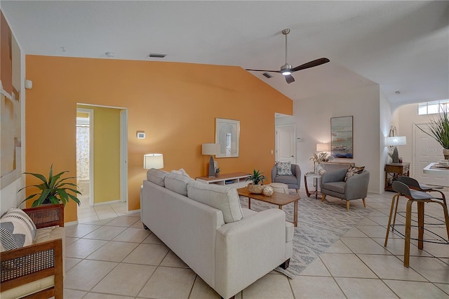 tiled living room featuring lofted ceiling and ceiling fan