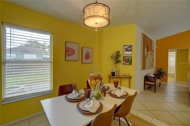 tiled dining area with lofted ceiling