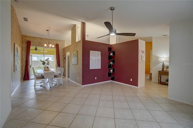 unfurnished dining area with ceiling fan with notable chandelier and light tile patterned floors