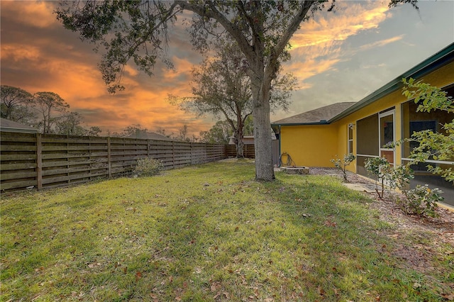 view of yard at dusk