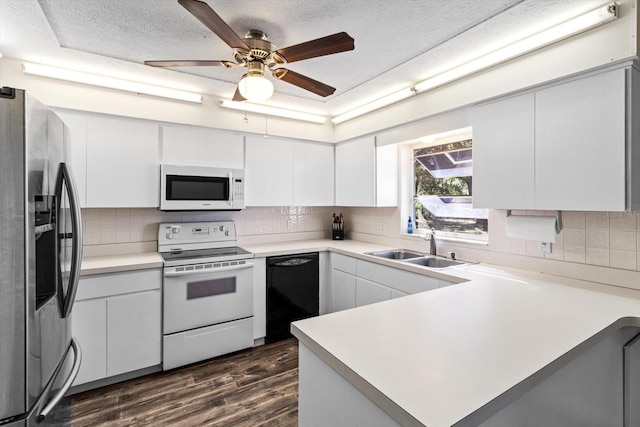 kitchen featuring sink, tasteful backsplash, dark hardwood / wood-style flooring, white appliances, and white cabinets