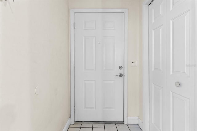 doorway to outside featuring light tile patterned flooring