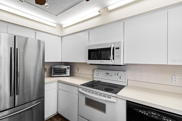 kitchen featuring tasteful backsplash, white appliances, and white cabinets