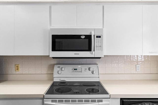 kitchen featuring backsplash, white cabinets, and white appliances