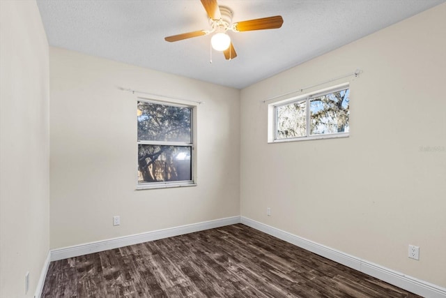 spare room with ceiling fan, dark hardwood / wood-style floors, and a textured ceiling