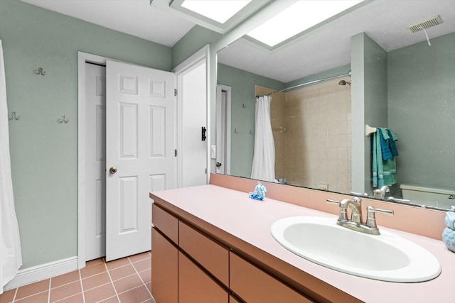 bathroom featuring walk in shower, tile patterned floors, toilet, and vanity