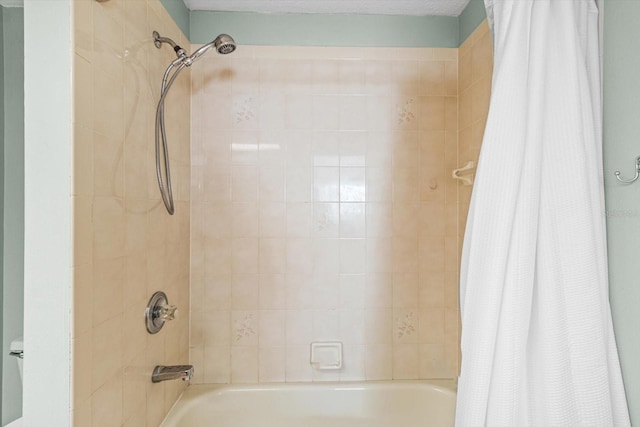 bathroom with shower / bath combo with shower curtain