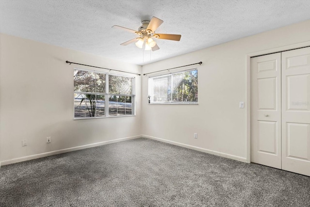 unfurnished bedroom with ceiling fan, a closet, carpet floors, and a textured ceiling