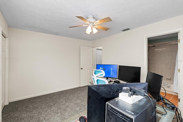 office featuring ceiling fan, carpet floors, and a textured ceiling