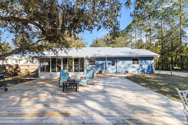 back of house featuring a sunroom and a deck