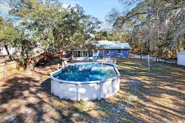 view of pool with a yard