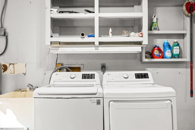 washroom with sink and washer and dryer