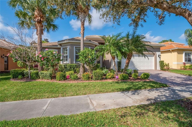 mediterranean / spanish-style house with a garage and a front yard