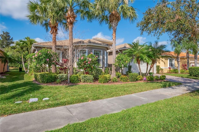 mediterranean / spanish-style house with a front lawn