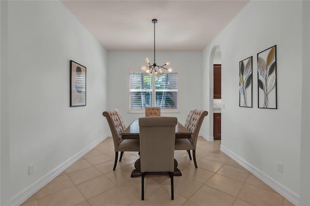 dining space with light tile patterned flooring and an inviting chandelier