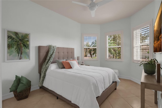 tiled bedroom with multiple windows and ceiling fan