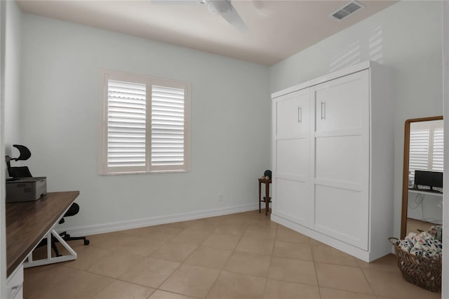 office with light tile patterned floors and ceiling fan