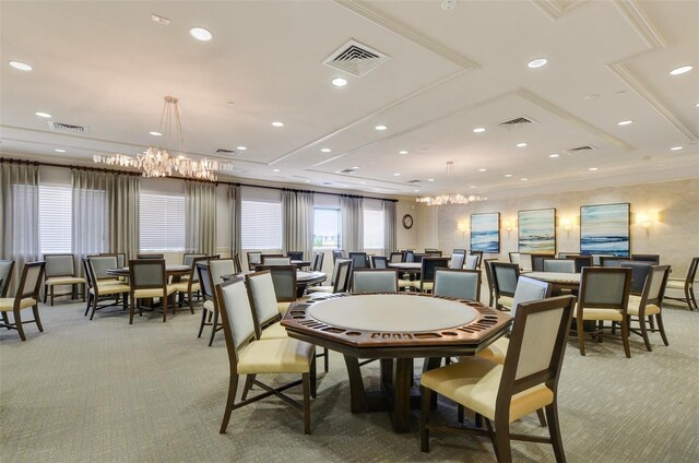 carpeted dining area with crown molding and a notable chandelier