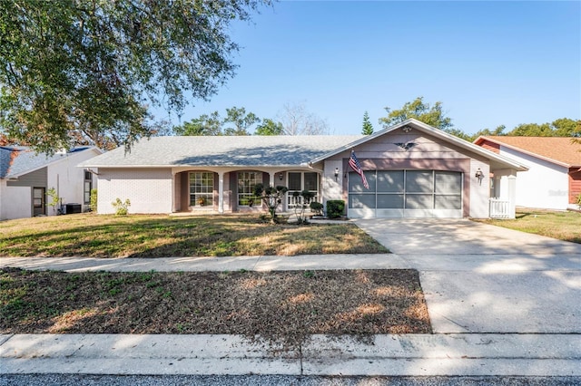 single story home featuring cooling unit, a garage, a front lawn, and a porch