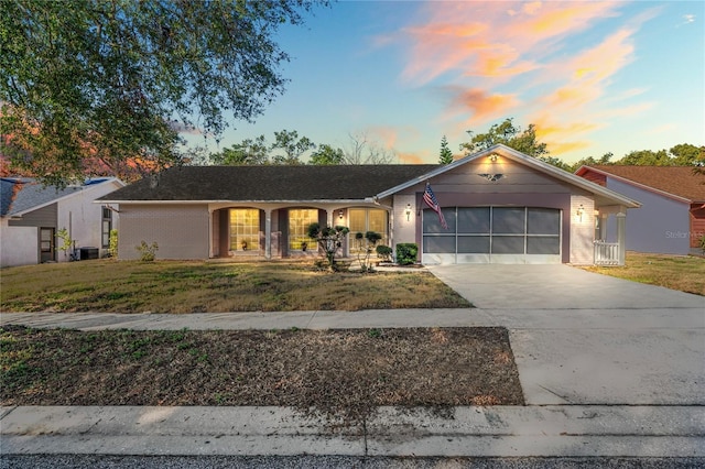 single story home featuring a garage and central AC