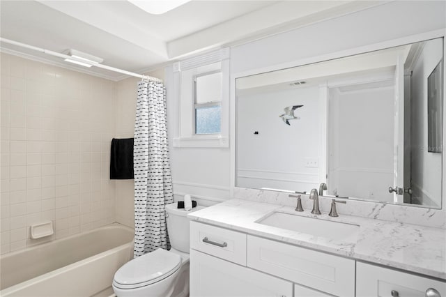 full bathroom featuring vanity, shower / tub combo with curtain, and toilet