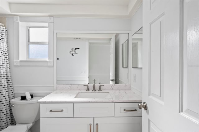 bathroom featuring vanity and toilet