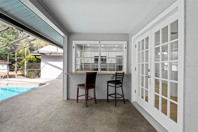 sunroom / solarium featuring french doors and sink