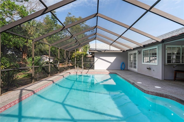 view of swimming pool featuring glass enclosure