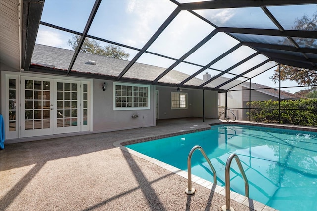 view of swimming pool with a patio, glass enclosure, and french doors