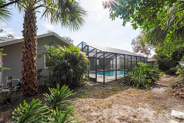 view of pool featuring glass enclosure