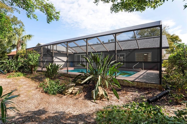 view of swimming pool with a patio and a lanai