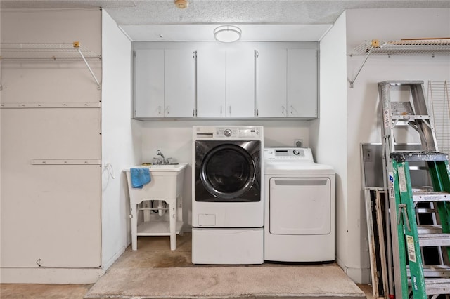 washroom with cabinets and washer and dryer