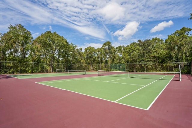 view of tennis court featuring basketball hoop