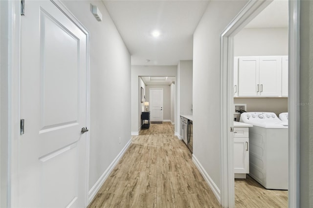 hall featuring light wood-type flooring and baseboards