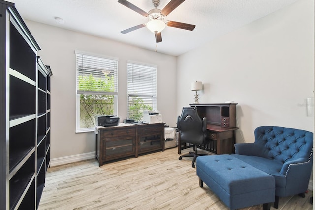 home office with ceiling fan, light wood finished floors, and baseboards