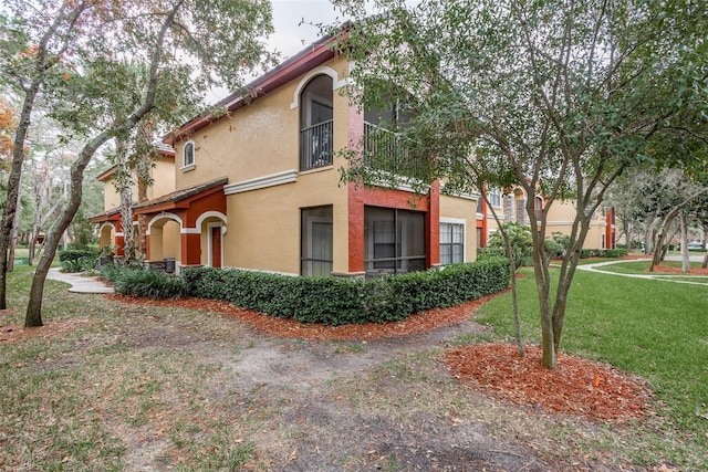 view of property exterior with a lawn