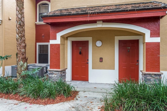 view of exterior entry with central air condition unit