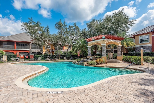 view of swimming pool featuring pool water feature and a patio area