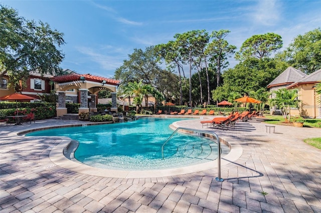 view of pool with a patio area and pool water feature