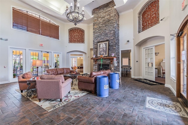 living room featuring a notable chandelier, a fireplace, and ornamental molding