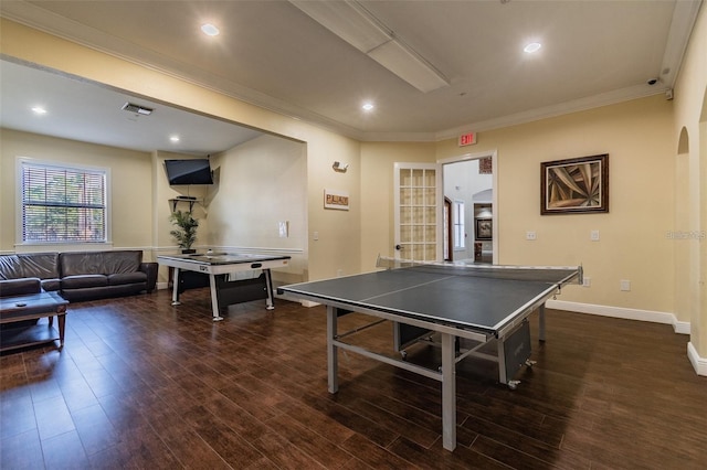 recreation room featuring ornamental molding and dark hardwood / wood-style flooring