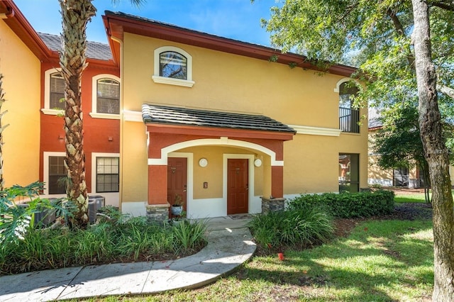 view of front of house with central AC and stucco siding