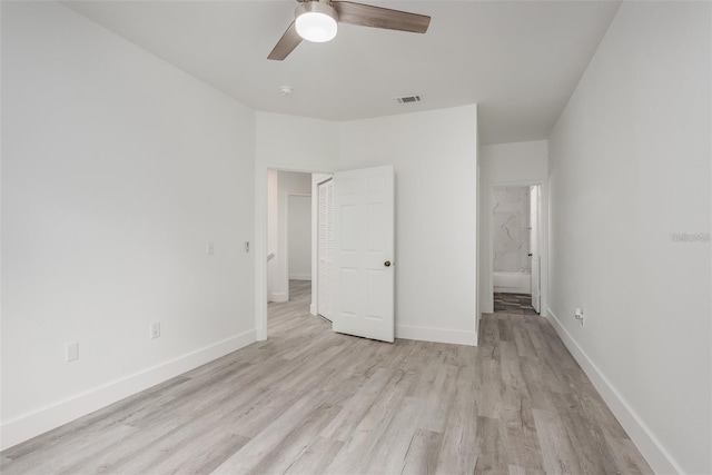 unfurnished bedroom featuring ceiling fan, connected bathroom, and light wood-type flooring