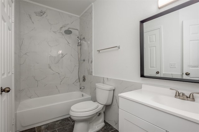 full bathroom featuring tiled shower / bath combo, vanity, tile walls, and toilet