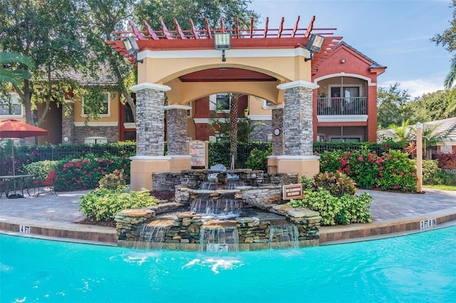 view of swimming pool featuring a patio and pool water feature