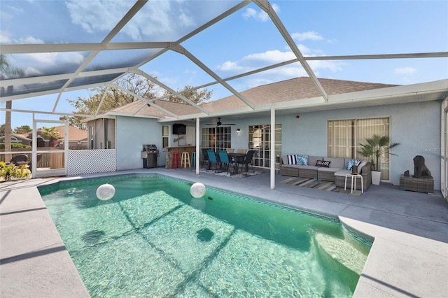 view of pool featuring an outdoor living space, a lanai, an outdoor bar, and a patio area