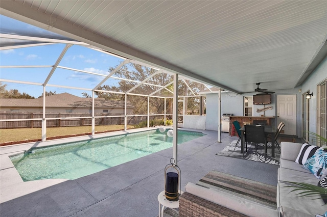 view of pool with a lanai, an outdoor hangout area, ceiling fan, and a patio area