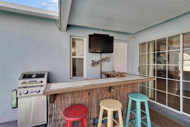 view of patio / terrace with a grill and a bar