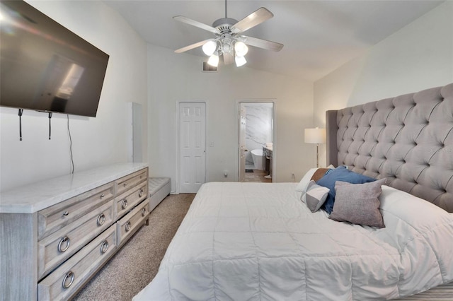 bedroom with vaulted ceiling, carpet floors, ceiling fan, and ensuite bath