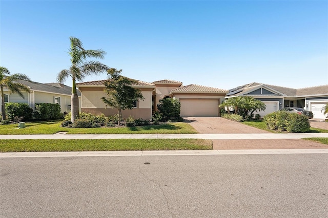 view of front of home featuring a garage and a front yard